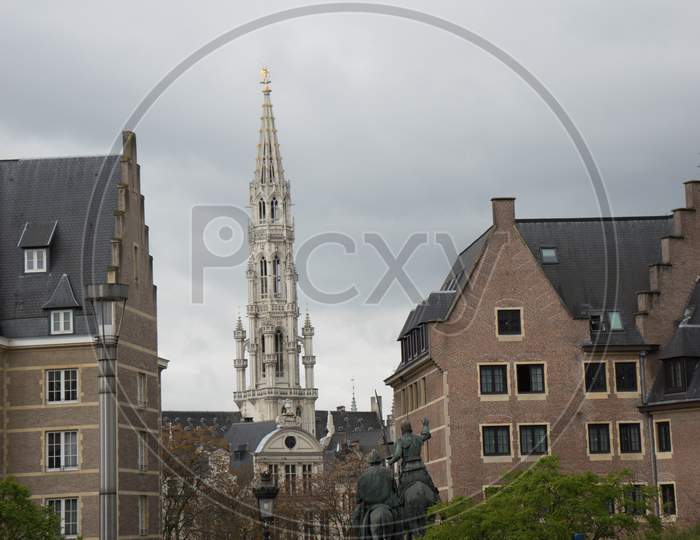 Brussels, Belgium - April 14 : A Taxi Cab Is Parked On A Road With The Belfry Tower And Horse Statue In The Background In Brussels, Belgium On April 14, 2017