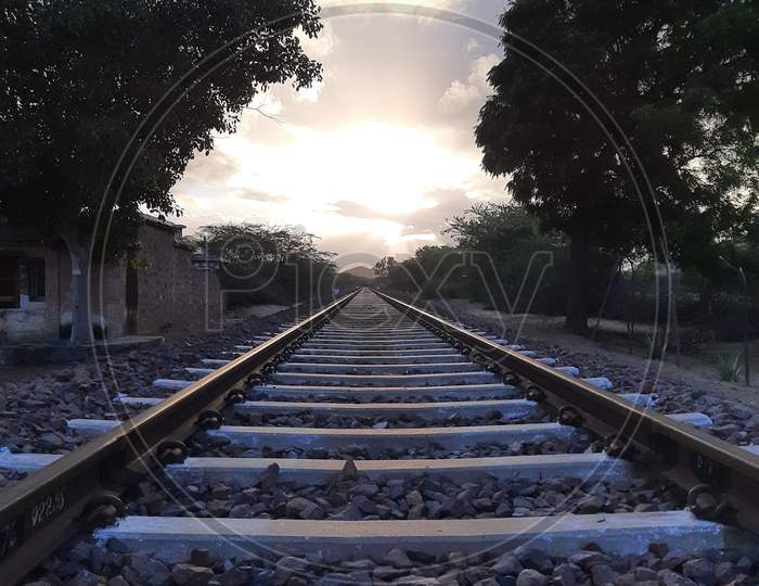 Combination of sky, clouds,sunlight,railway track and nature.