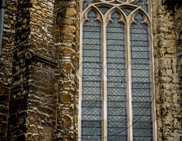 An Arched Window On Sint-Jacobskerk Monumental Church Featuring 12Th-Century Romanesque Towers & A 13Th-Century Gothic Central Spire In Gent, Belgium,