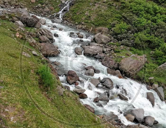 Beautiful River Stream Flowing Through Rocks In Indian Himalayan Mountain Valley.