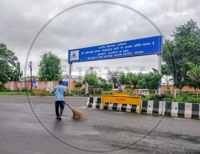 Indore, India - August 22Nd 2020: Municipality Worker Cleaning Road Outside Indore Airport. Cleanest City In India 2020.