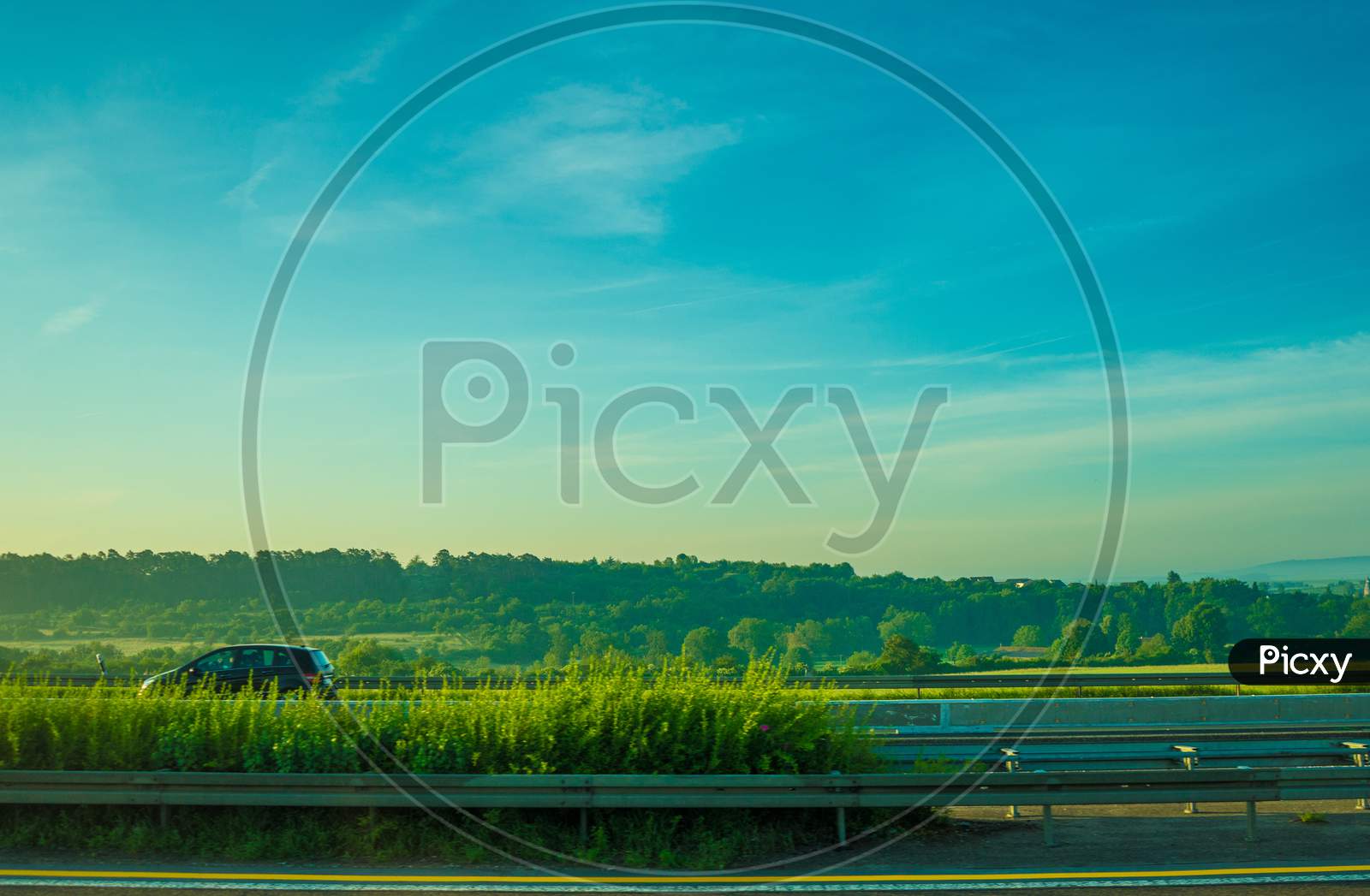 Germany, Frankfurt, Sunrise, A Large Green Landscape With A Body Of Water