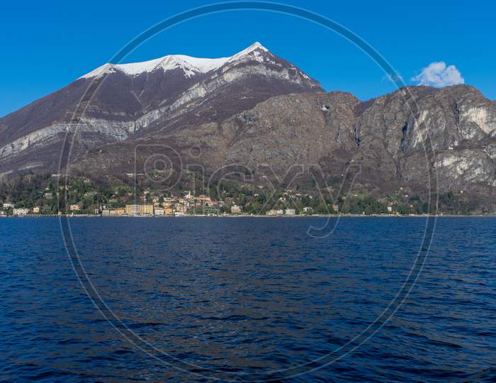 Italy, Bellagio, Lake Como, Cadenabbia, Scenic View Of Sea And Mountains Against Blue Sky