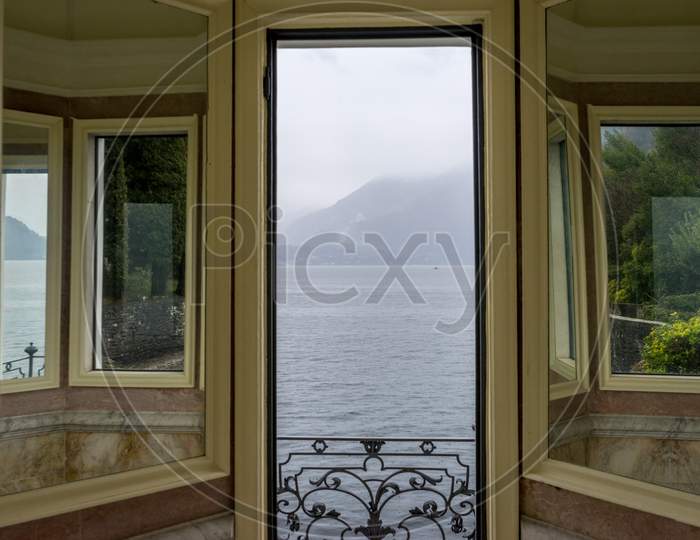 Italy, Varenna, Lake Como Viewed Through A Door Window
