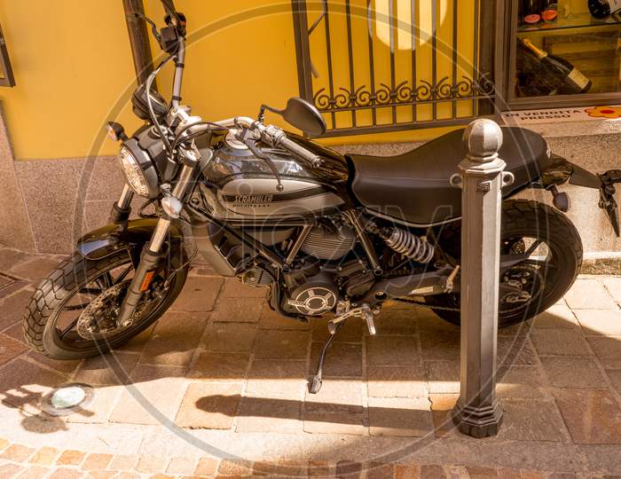 Menaggio, Italy-April 2, 2018: Ducati Scrambler Bike Parked On Road At Menaggio, Lombardy