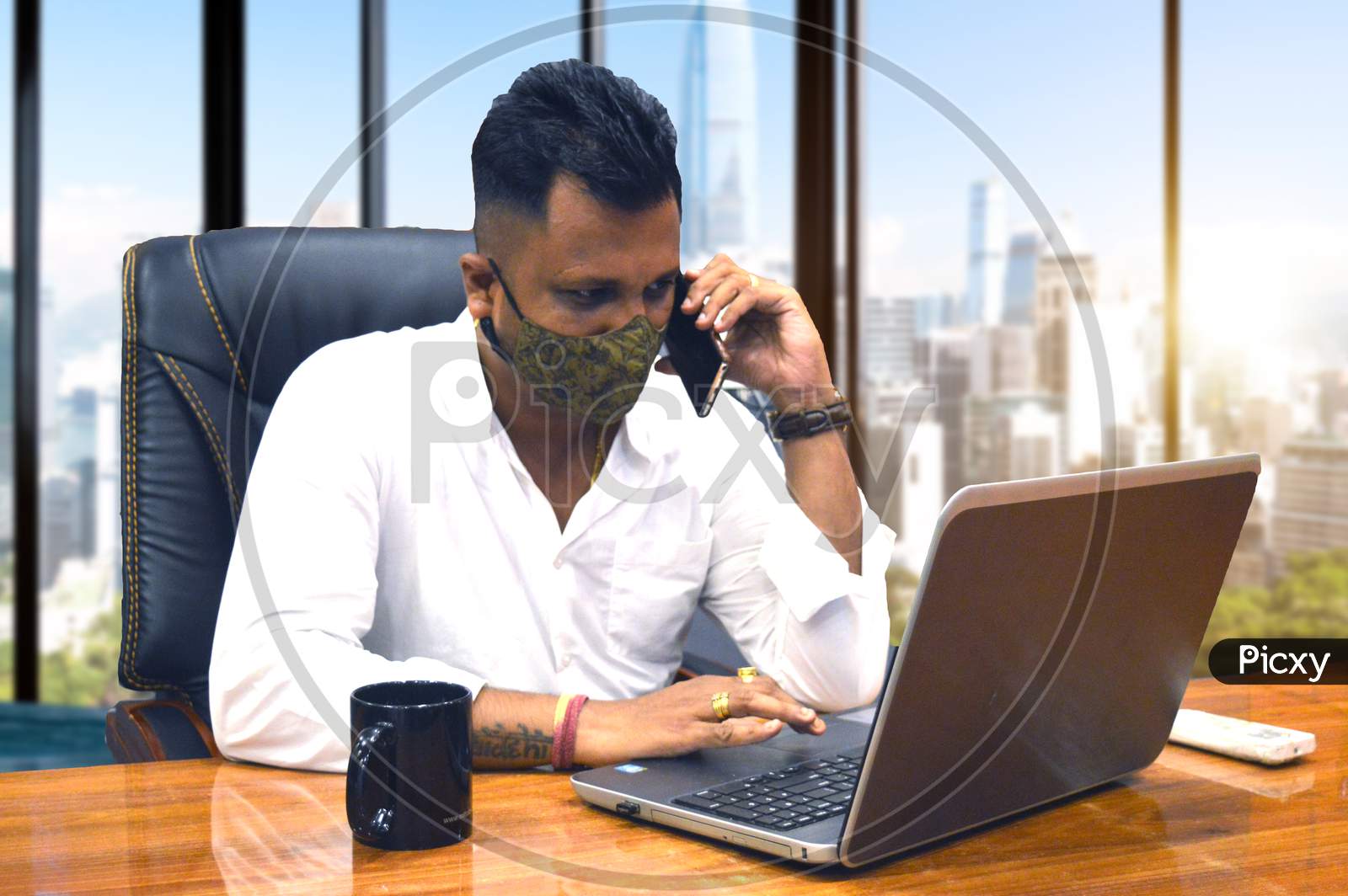 Man on Phone with mask working in office