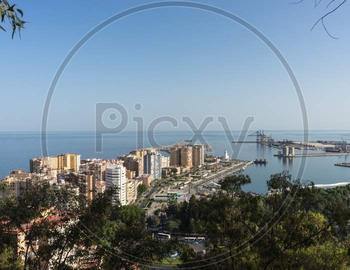 City Skyline Of Malaga Overlooking The Sea Ocean In Malaga, Spain, Europe On A Bright Summer Day