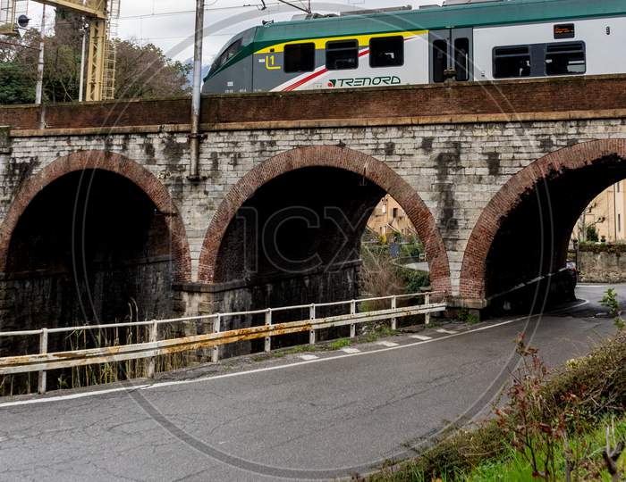 Varenna, Italy- March 31, 2018: Treinitalia Trenord Train At Varenna, Italy Travelling Over A Bridge
