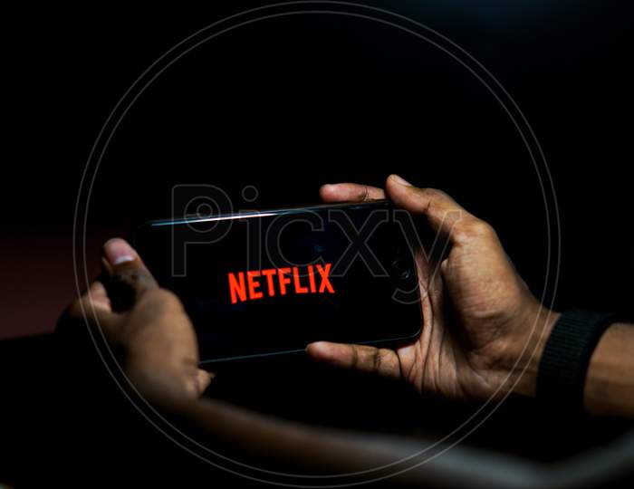 Netflix Mobile App Icon Opening on Smartphone Screen Closeup