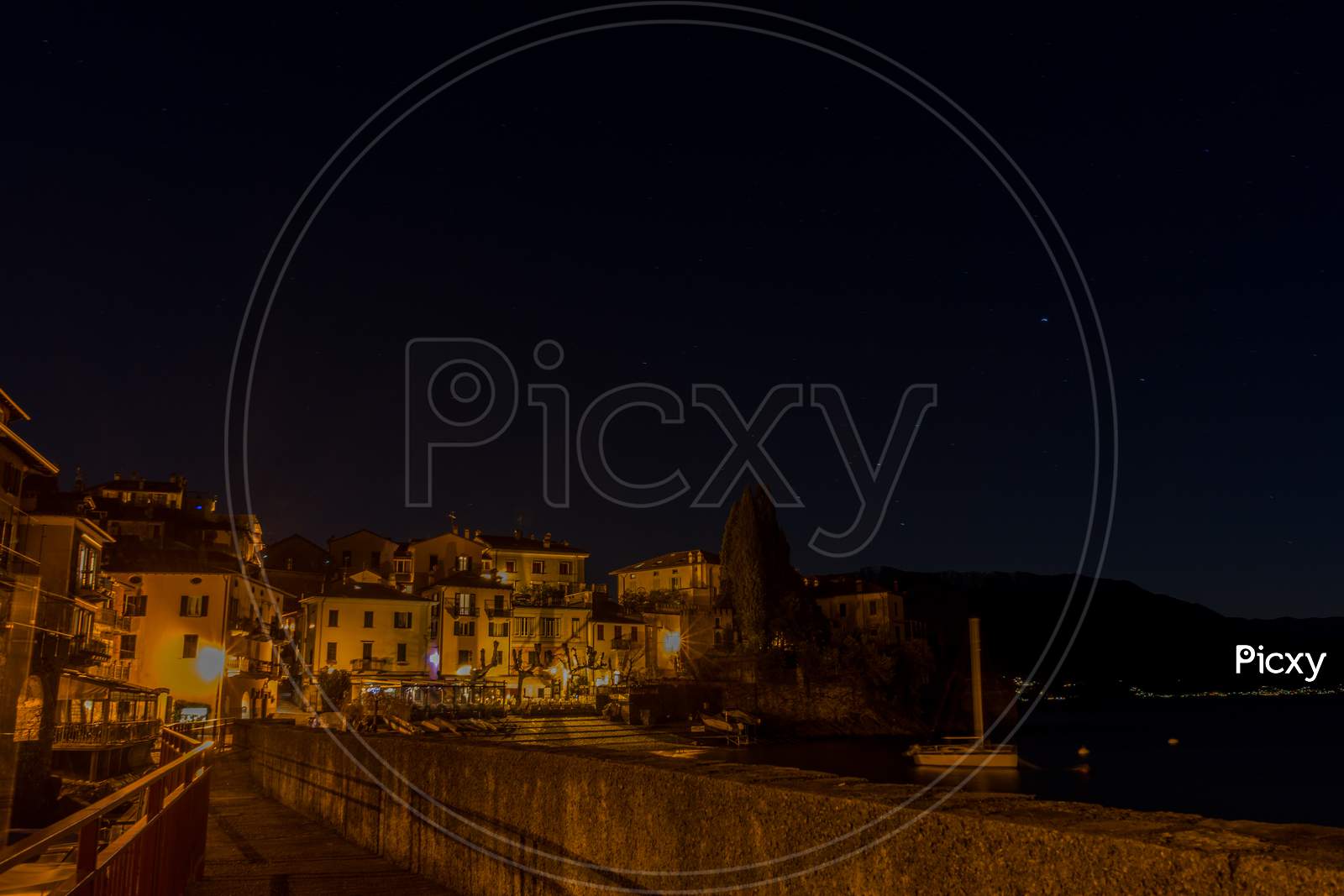 Italy, Lecco, Lake Como, A View Of A City At Night