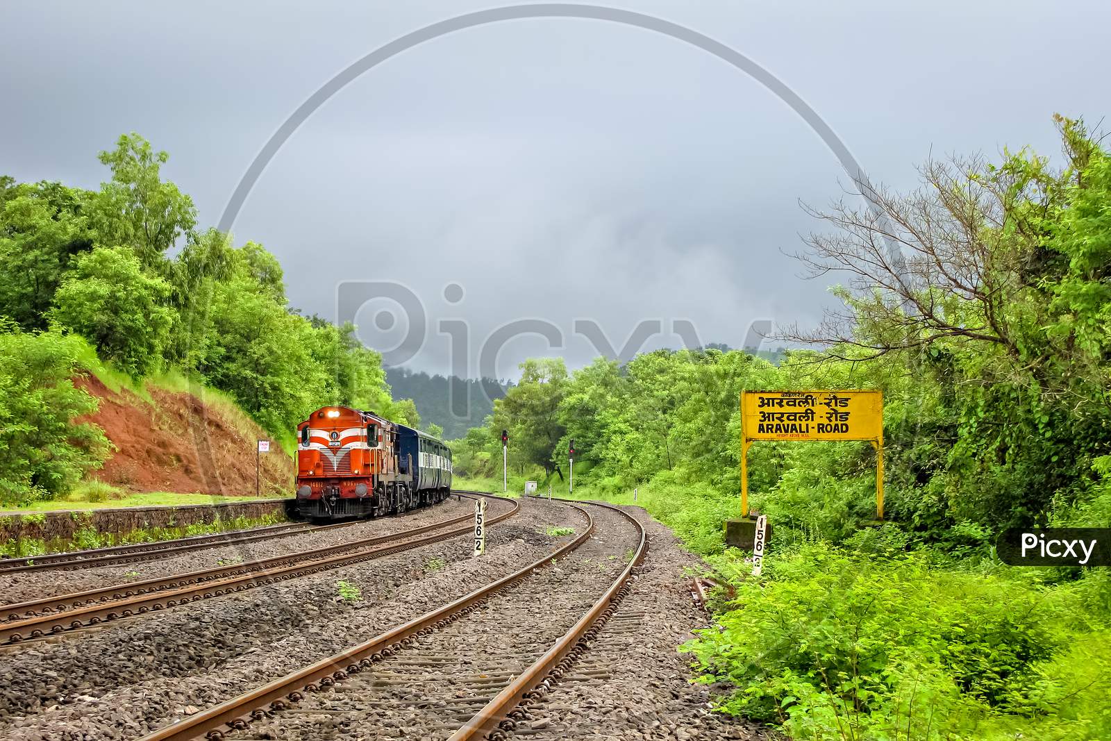 Indian Railway'S Passenger Carrying Train Entering A Beautiful, Scenic Station,