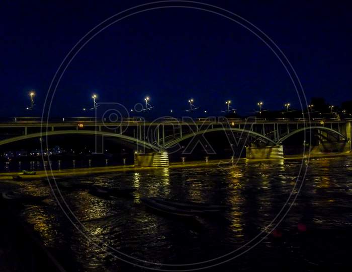Switzerland, Basel, Illuminated Bridge Over Rhine River Against Sky In City At Night