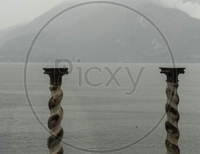 Italy, Varenna, Lake Como,Pillars Overlooking A Lake