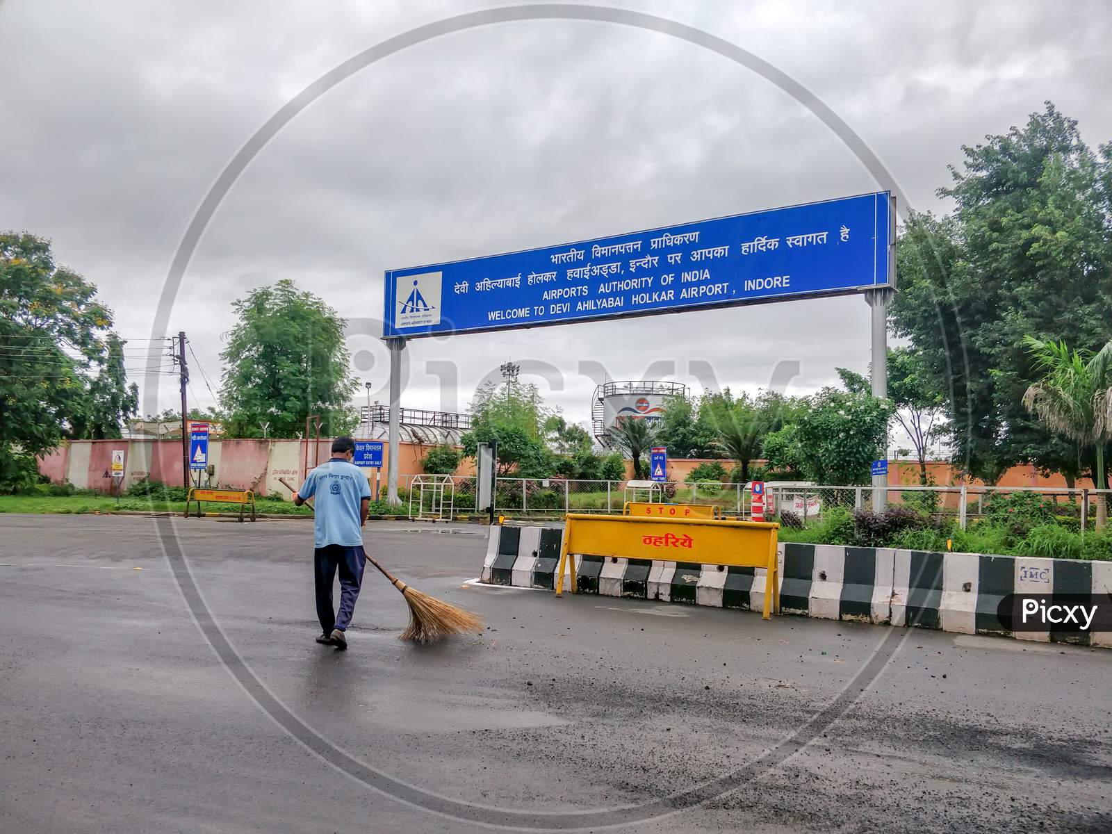 Indore, India - August 22Nd 2020: Municipality Worker Cleaning Road Outside Indore Airport. Cleanest City In India 2020.