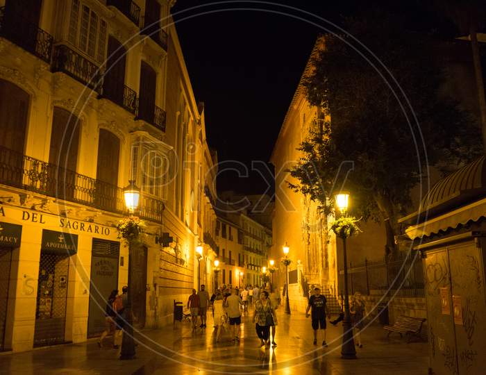 Malaga, Spain - June 24: Tourists Walk Past The Dimly Lit Street Of Malaga, Spain, Europe, Andalusia