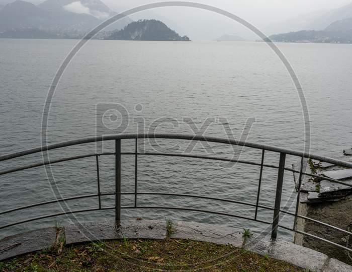 Italy, Varenna, Lake Como, A Bridge Over A Body Of Water