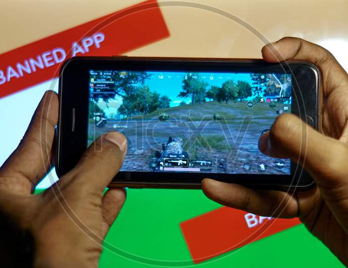 Close up shot of a Person playing Banned PubG Mobile Game in Smartphone with Indian Flag In the Background