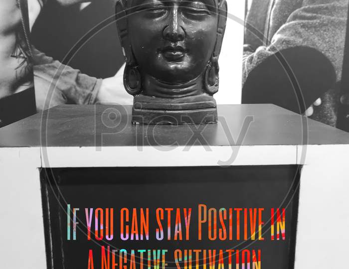 Black coloured home decor piece of Buddha, With the quote. coloured Text