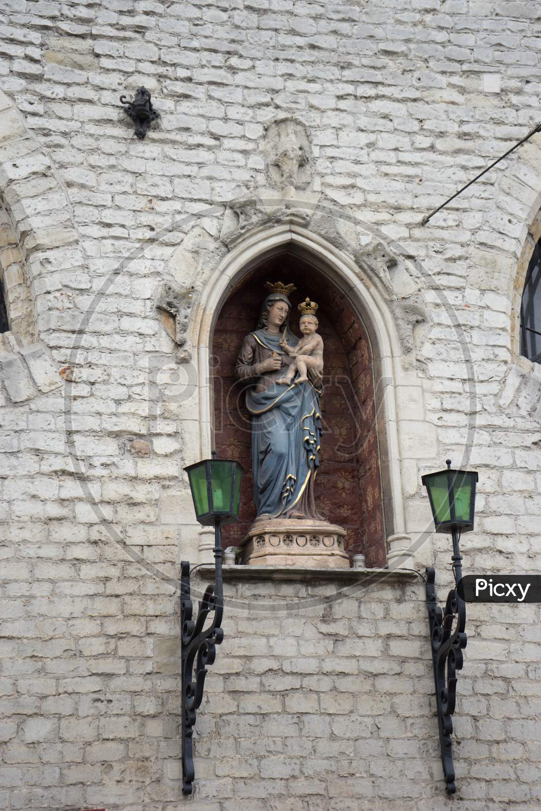 Sculpture Of Mary Holding Baby Jesus On A Wall In The City Of Ghent, Belgium