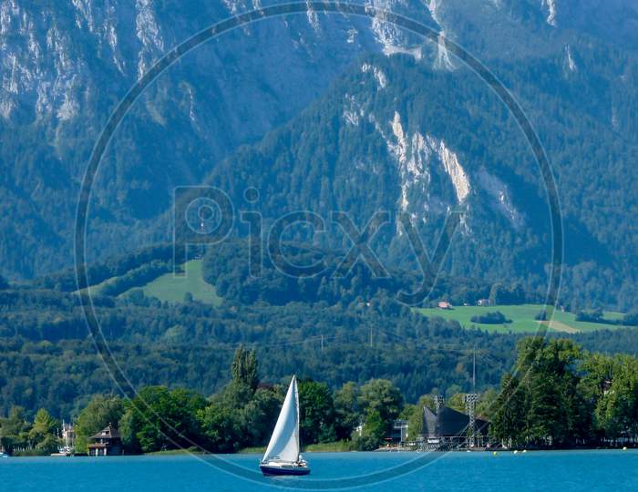 Switzerland, Lauterbrunnen, Sailboat Sailing On Sea Against Mountains