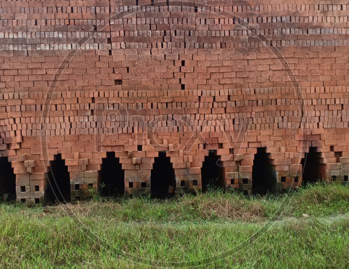 Red Raw Bricks Stack In A Row , Coconut Trees