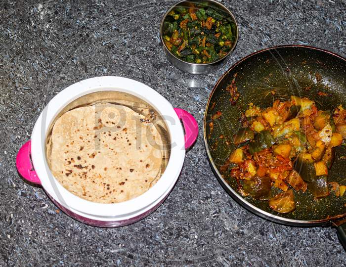 Roti with potato and brinjal and lady finger fry