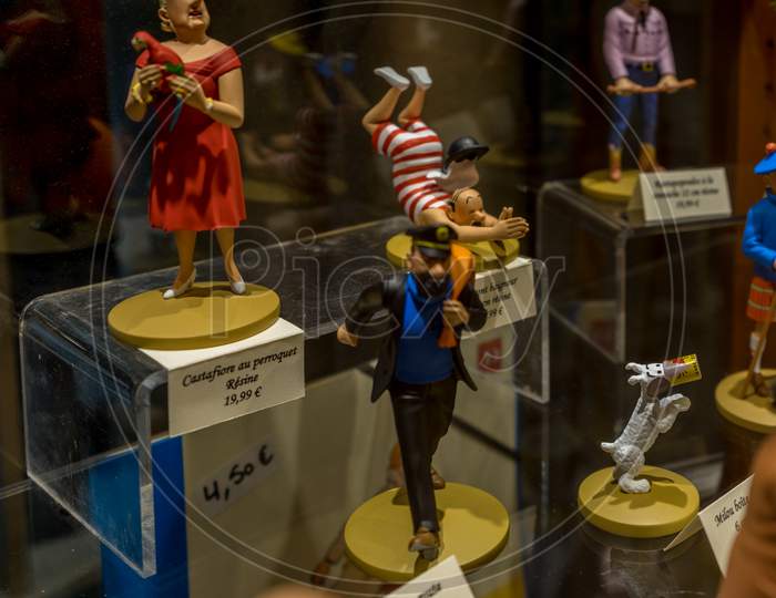 Brussels, Belgium - April 17 : Tintin, Haddock And Snowy Comics And Sculptures Are Displayed In A Window Of A Shop In Brussels, Belgium On April 17, 2017