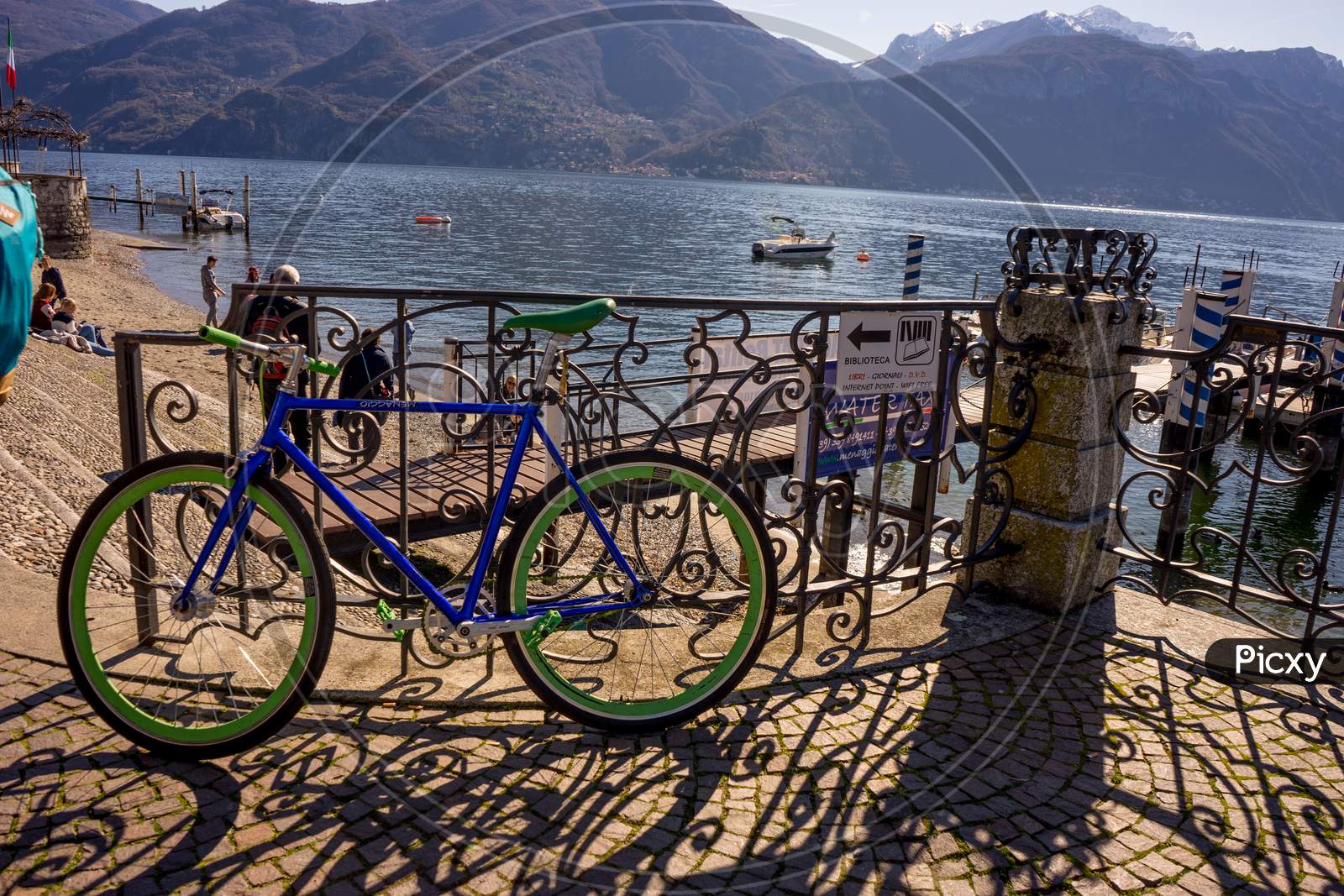 Menaggio, Italy-April 2, 2018: Blue Bicycle Parked At The Waterside Quay, Menaggio, Lombardy