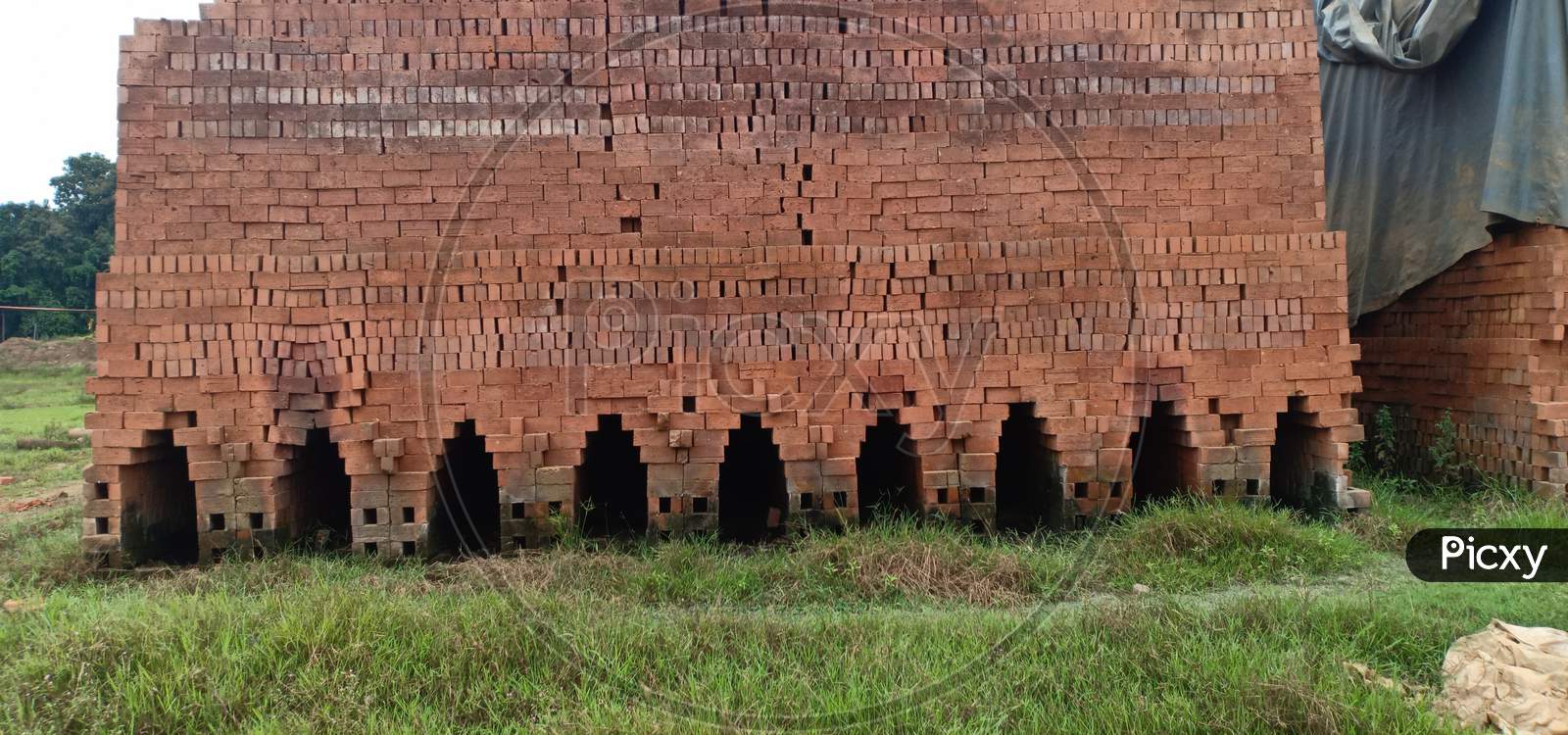 Red Raw Bricks Stack In A Row , Coconut Trees