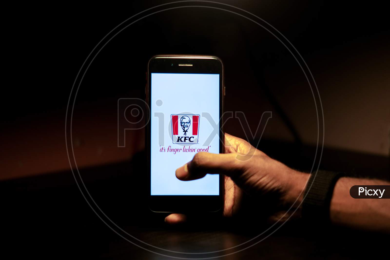 KFC Mobile App Icon Opening on Smartphone Screen Closeup With Finger