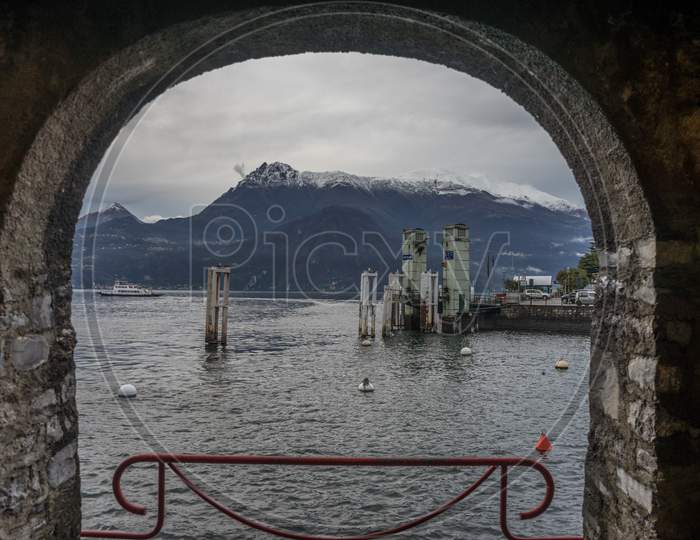 Italy, Varenna, Lake Como, Scenic View Of Moutain Through An Arch