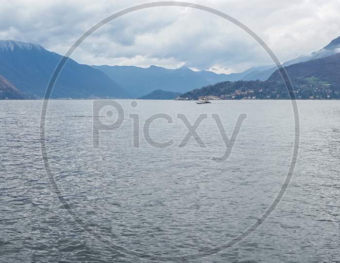 Varenna, Italy- March 31, 2018: A Boat On Lake Como Next To The Village Of Varenna