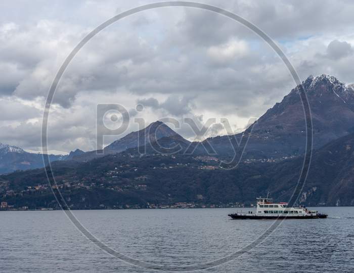 Varenna, Italy- March 31, 2018: A Boat On Lake Como Transporting Cars To The Village Of Varenna