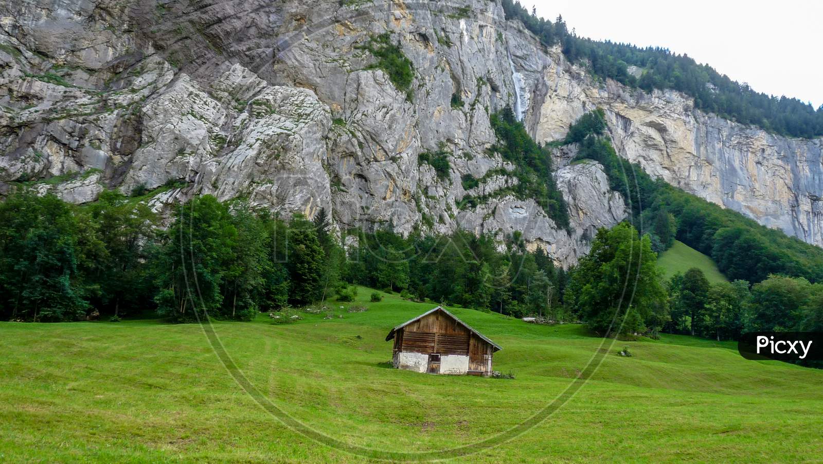Switzerland, Lauterbrunnen, Built Structure On Field Against Mountain