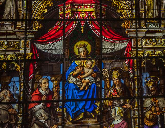 Painted Glass With Mary And Baby Jesus In The Interiors Of Saint Nicholas Church, Ghent, Belgium