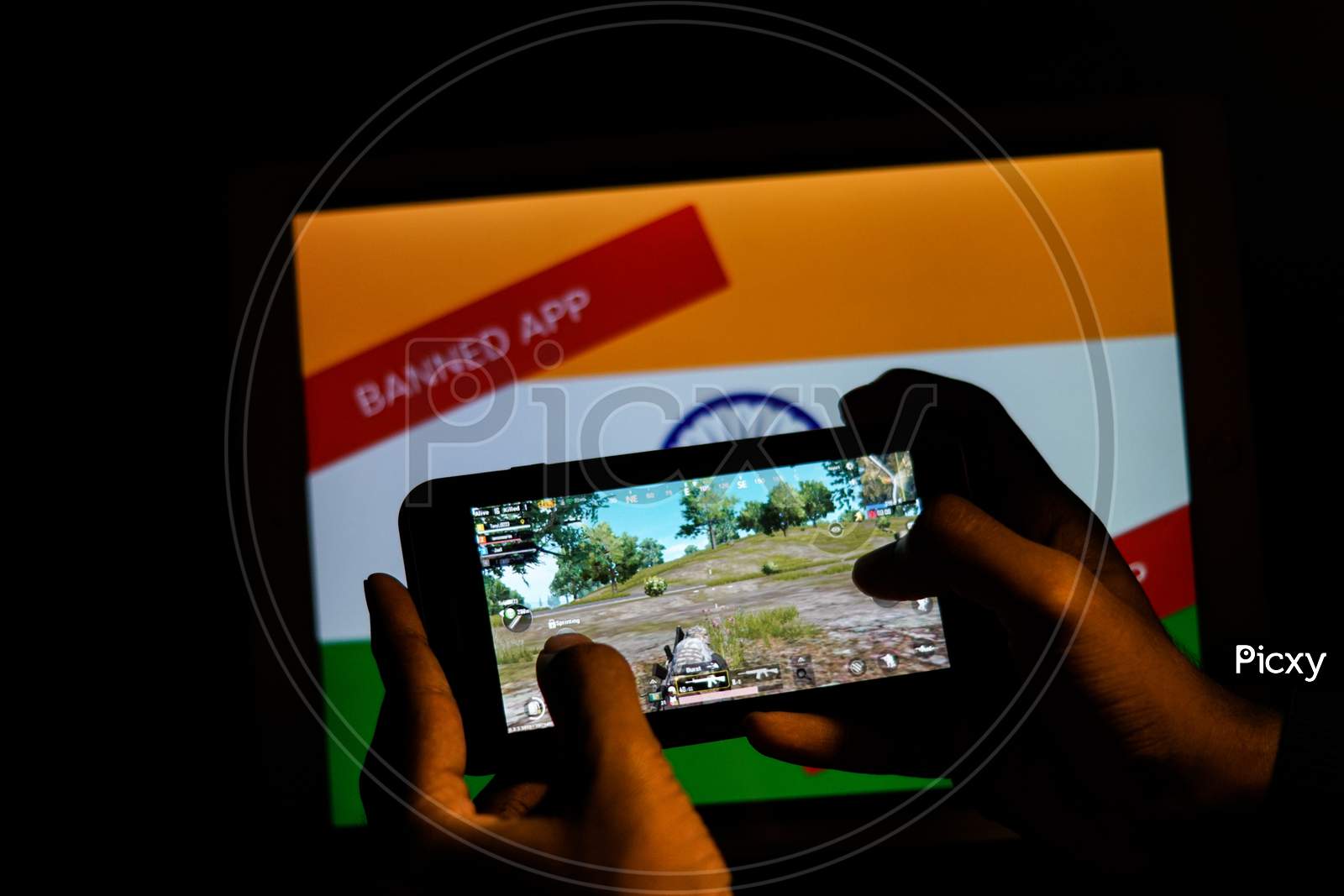 Close up shot of a Person playing Banned PubG Mobile Game in Smartphone with Indian Flag In the Background