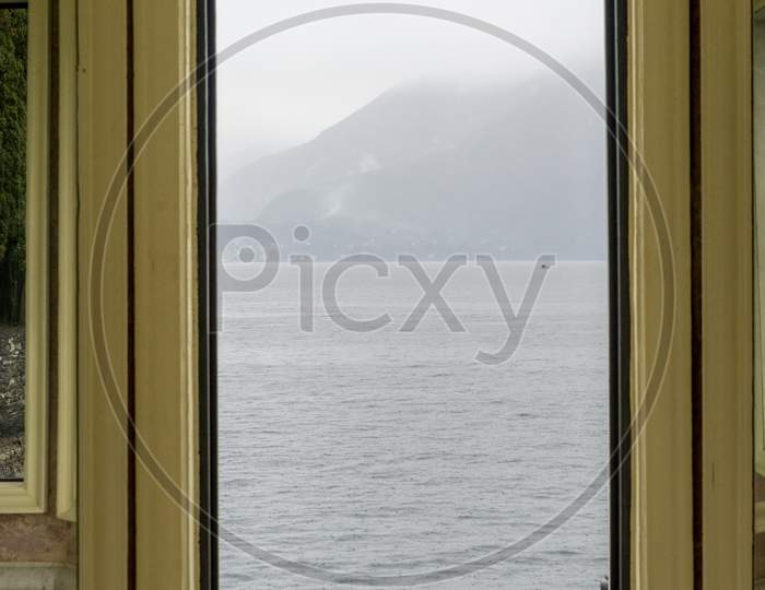 Italy, Varenna, Lake Como Viewed Through A Door Window