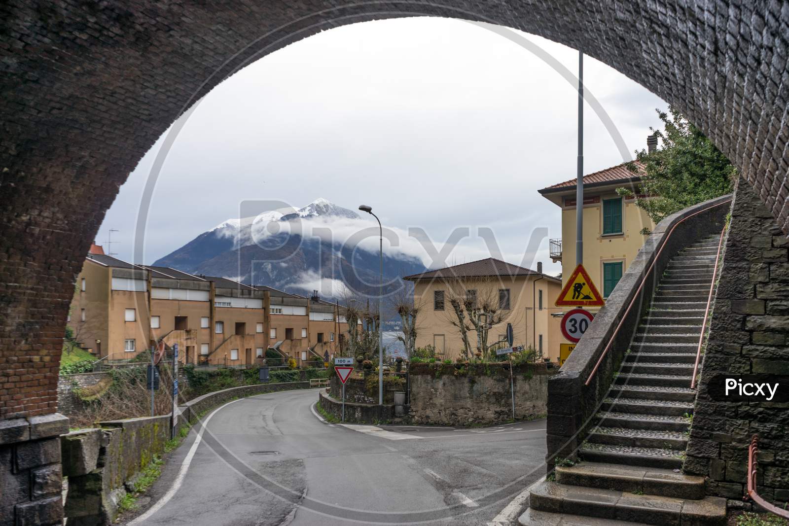 Italy, Varenna, Lake Como, Mountain Viewed Under An Arch