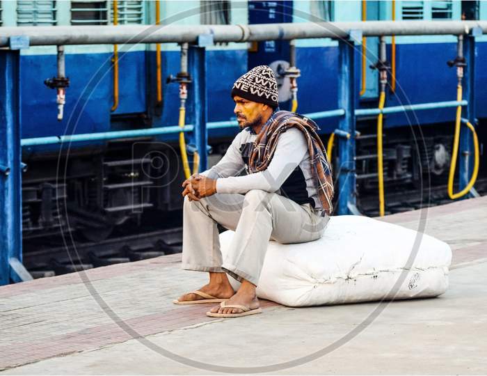 A man waiting for arrival of train to load luggage at Nizamabad  junction railway station