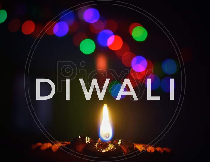 Diya and bokeh of lightning. Decoration on the occasion of Diwali. Indian festival.