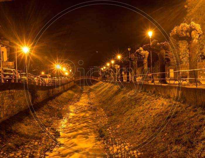Italy, Varenna, Lake Como, A Stream Flowing Down A Path At Night