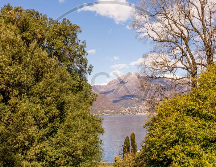 Italy, Bellagio, Lake Como, Scenic View Of River Amidst Trees Against Sky