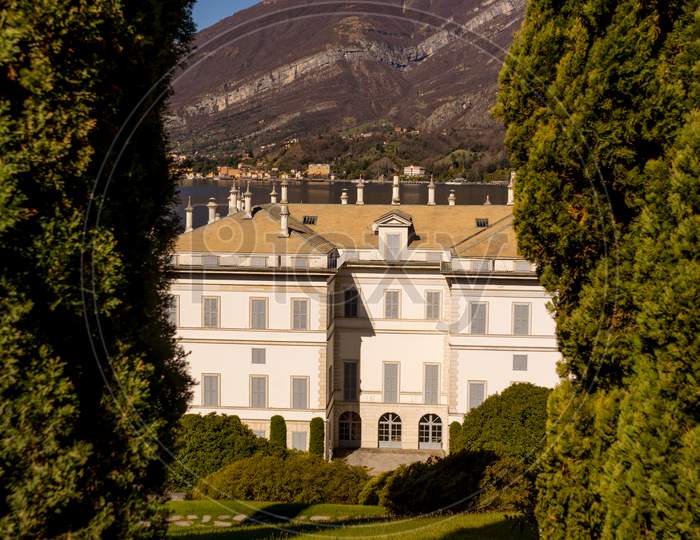 Bellagio, Italy-April 1, 2018: The Mansion At I Giardini Di Villa Melzi With Snow Capped Mountain Background
