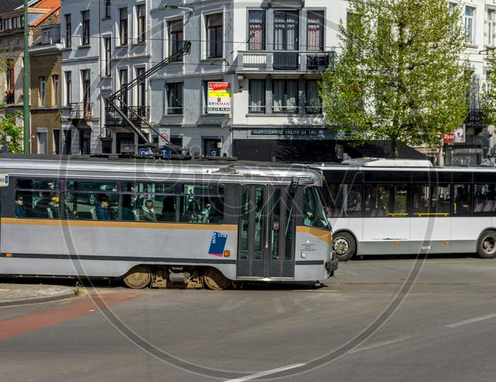 Brussels, Belgium - April 2017: A Tram And A Bus Cross Each Other In The City Of Brussels, Belgium