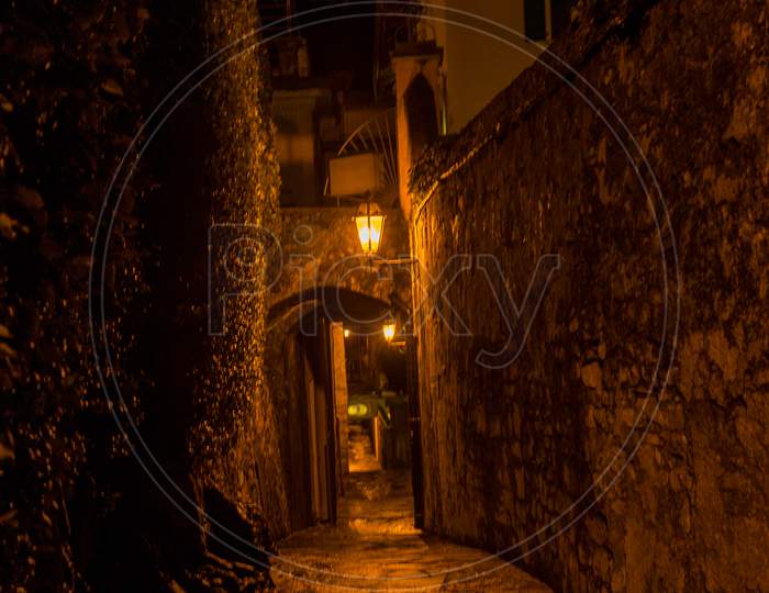 Italy, Varenna, Lake Como, Footpath Amidst Buildings In City At Night