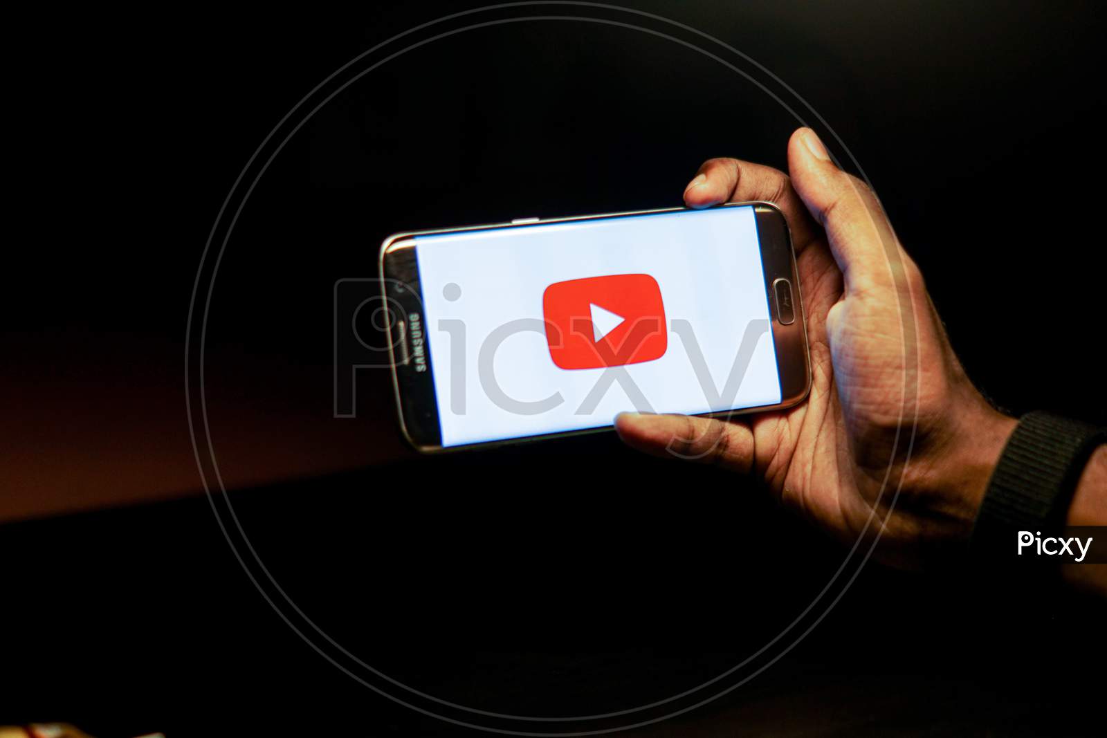 Youtube Mobile App Icon Opening on Smartphone Screen Closeup