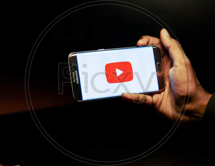 Youtube Mobile App Icon Opening on Smartphone Screen Closeup
