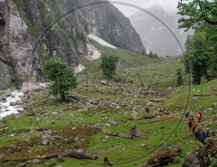 Manali, India - June 10Th 2019: Small Group Of Hikers Climbing Up A Indian Himalayan Mountain Valley.