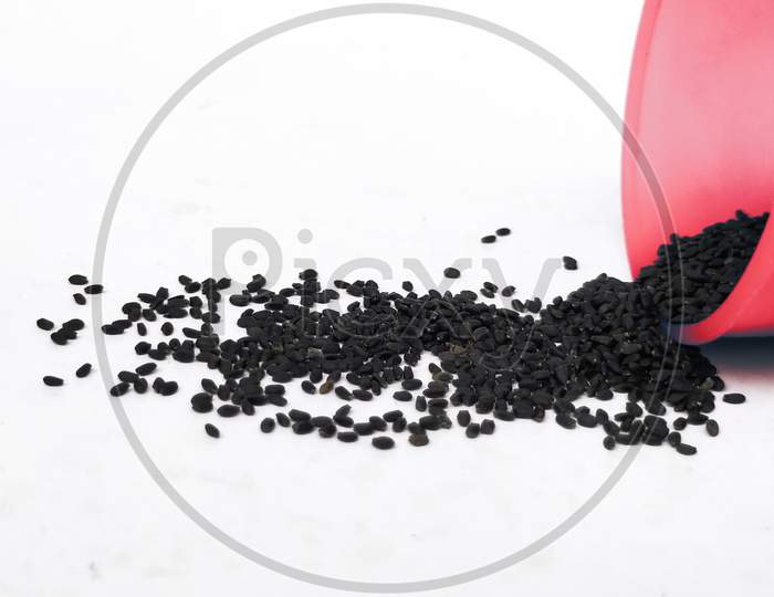 Chia Seeds Or Kama Kasturi Seed Scattered From Red Color Plastic Container Isolated On White Background.