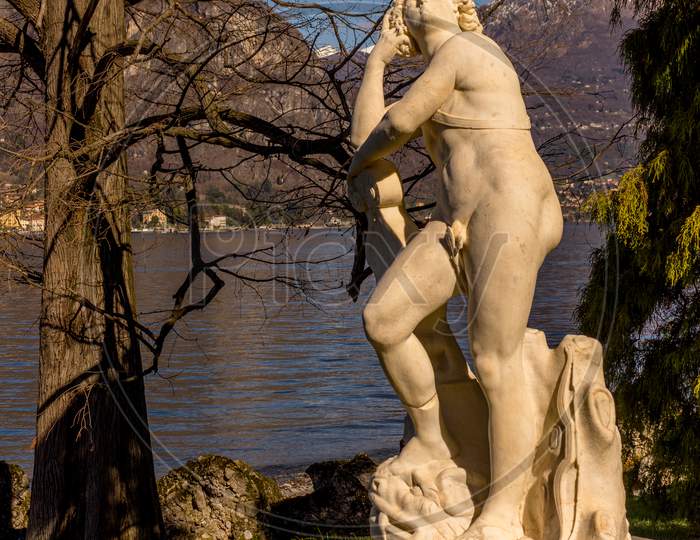 Bellagio, Italy-April 1, 2018: Statue Of Apollo By G.Della Porta 16Th Century At Giardini Di Villa Melzi